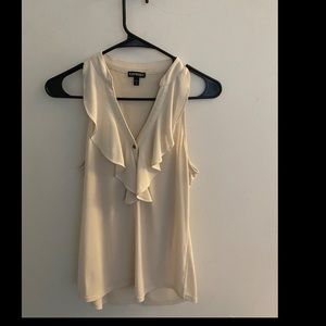 Off white colored sleeveless ruffle top